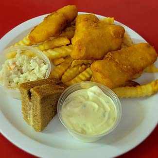 A sandwich with a side of fries and fish served at Butch's Pizza The Best Pizza in Kimberly, WI