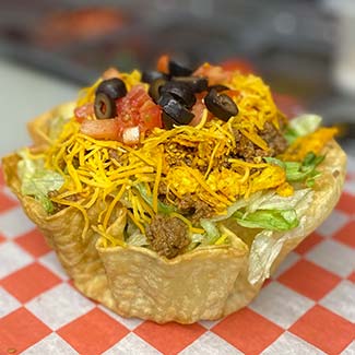 Taco salad topped with black olives, diced tomatoes, cheese and Mexican seasoned ground beef at Butch's Pizza restaurant in Kimberly, WI