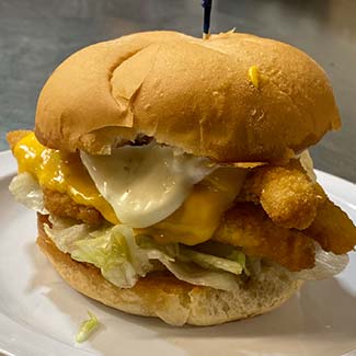 Crispy chicken or fish sandwich topped with melted cheese at Butch's Pizza restaurant in Kimberly, WI